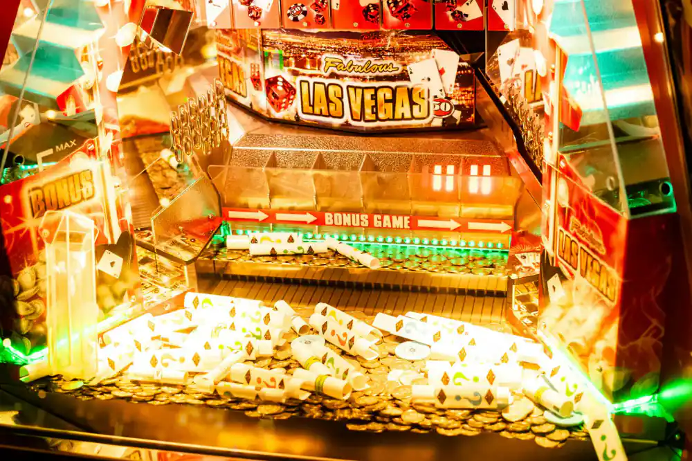 Glowing coin slot on an arcade machine